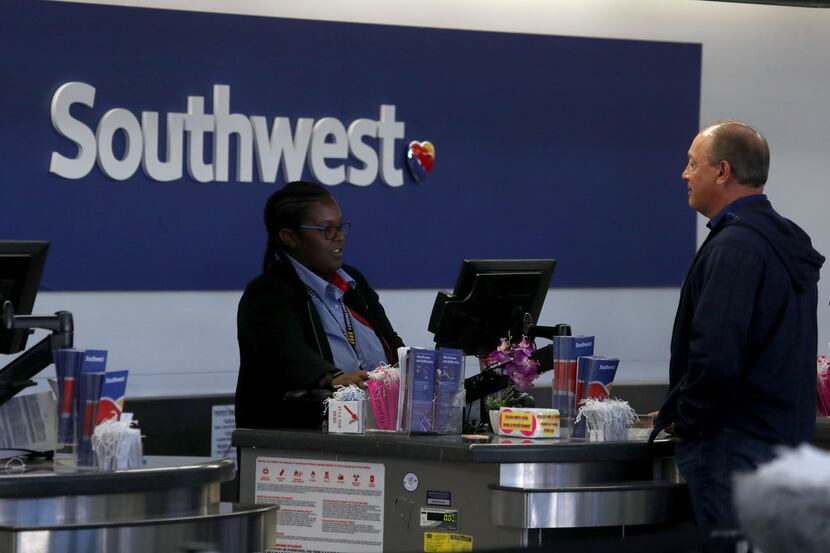A Southwest Airlines worker helps a customer at San Francisco International Airport.