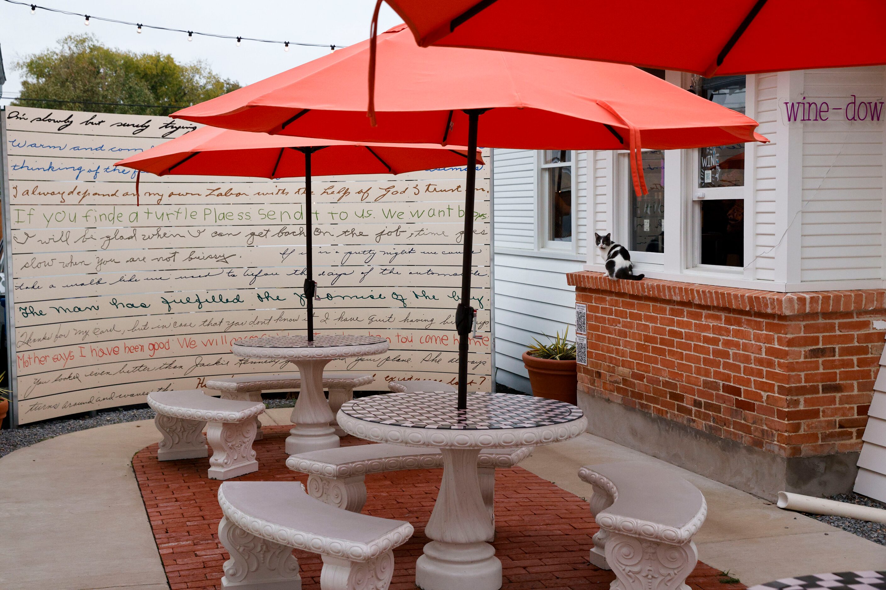 An outdoor seating area is seen outside of Ampelos wine bar and bottle shop along 8th Street...