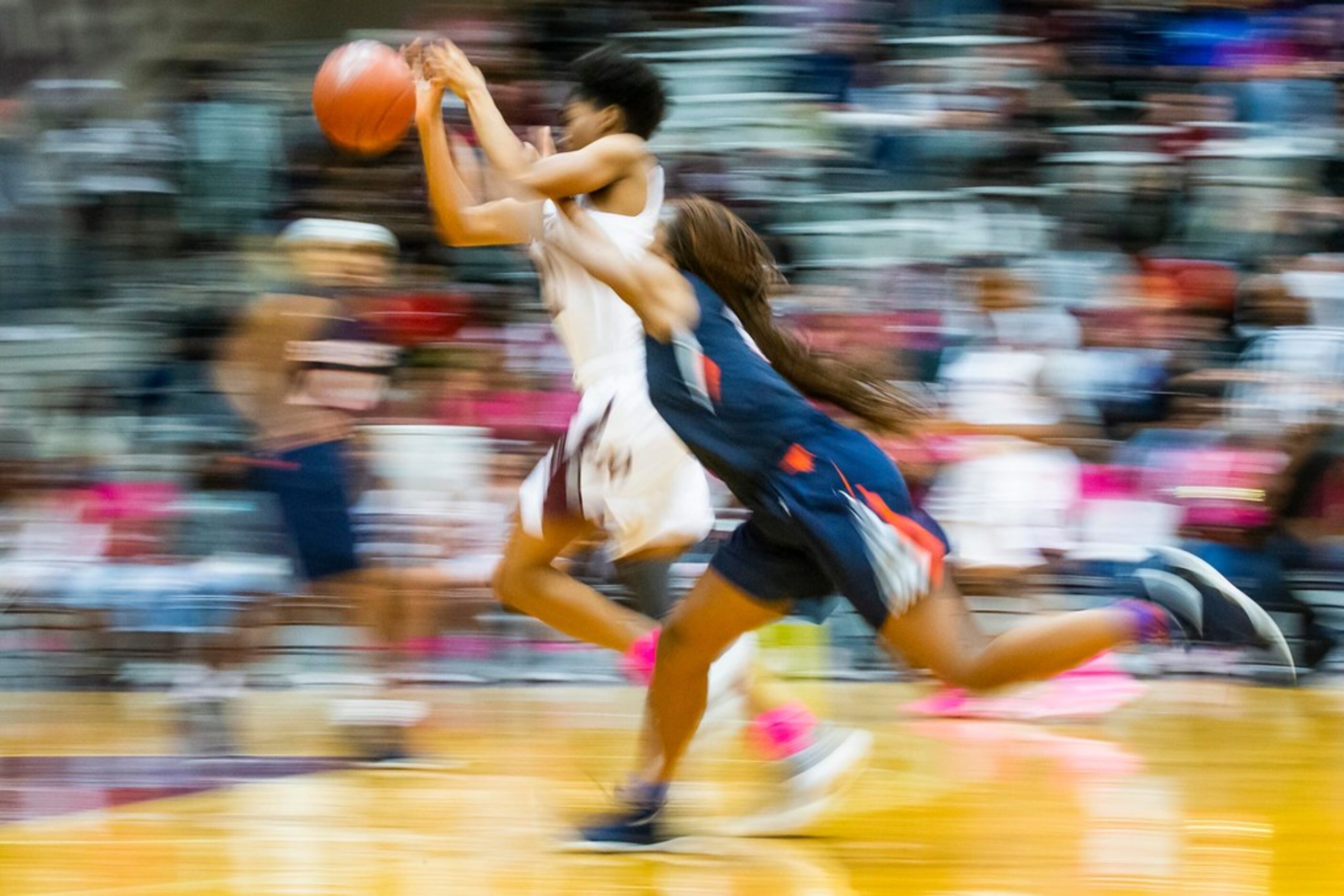 Sachse guard Tia Harvey (right) tries to steal the ball from Rowlett forward Ngozi Obineke...