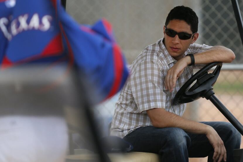 Texas general manager Jon Daniels watches the action during Texas Rangers baseball spring...