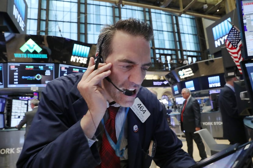 Traders work on the floor of the New York Stock Exchange (NYSE) following news that the...