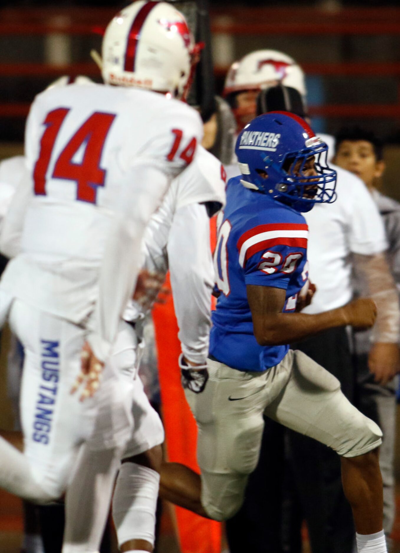 Duncanville running back Javon Fountain (20) eludes a couple of Richardson Pearce defenders...