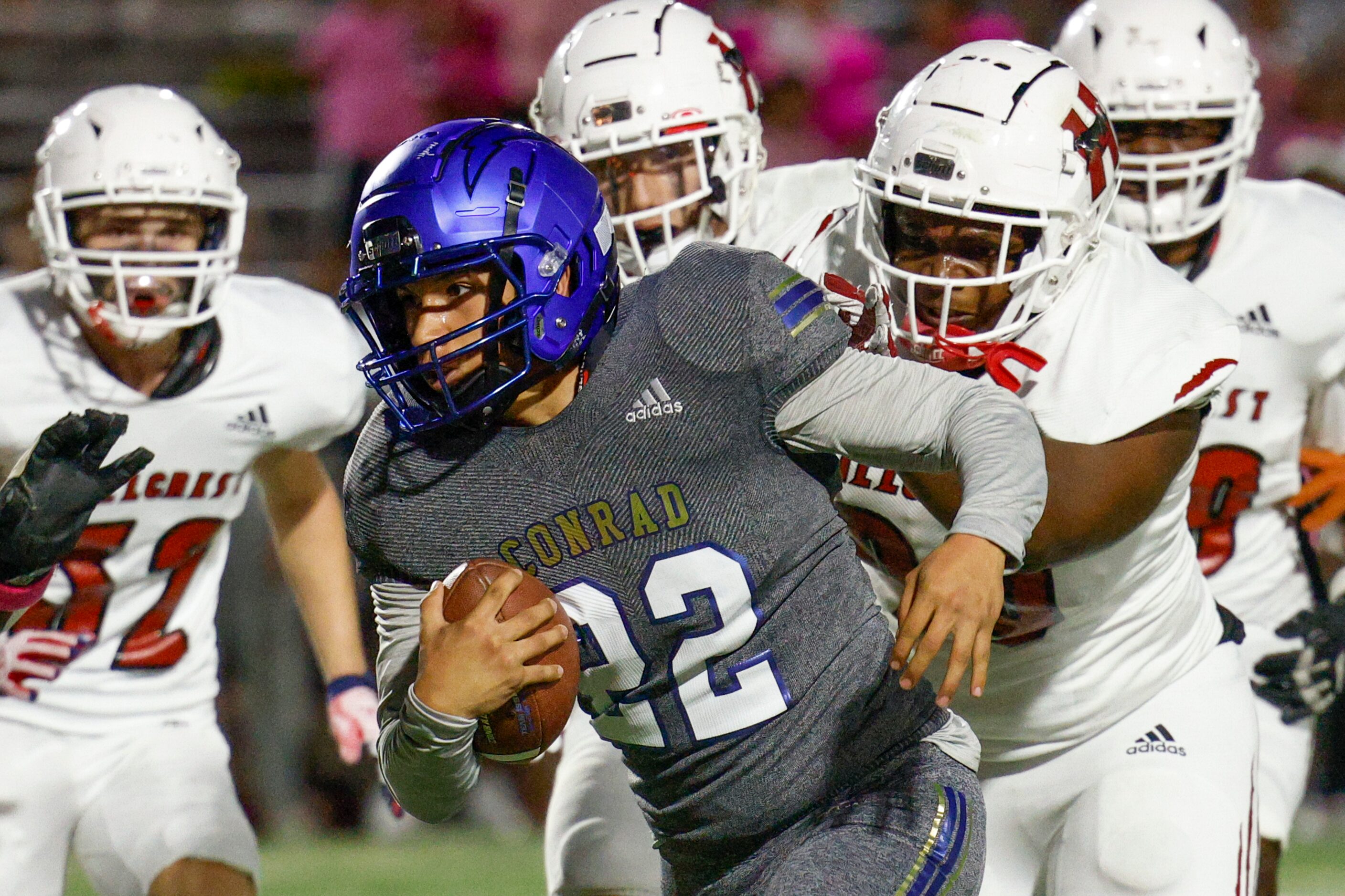 Conrad quarterback Brandon Nieto (22) runs the ball as Hillcrest defensive lineman Bryant...