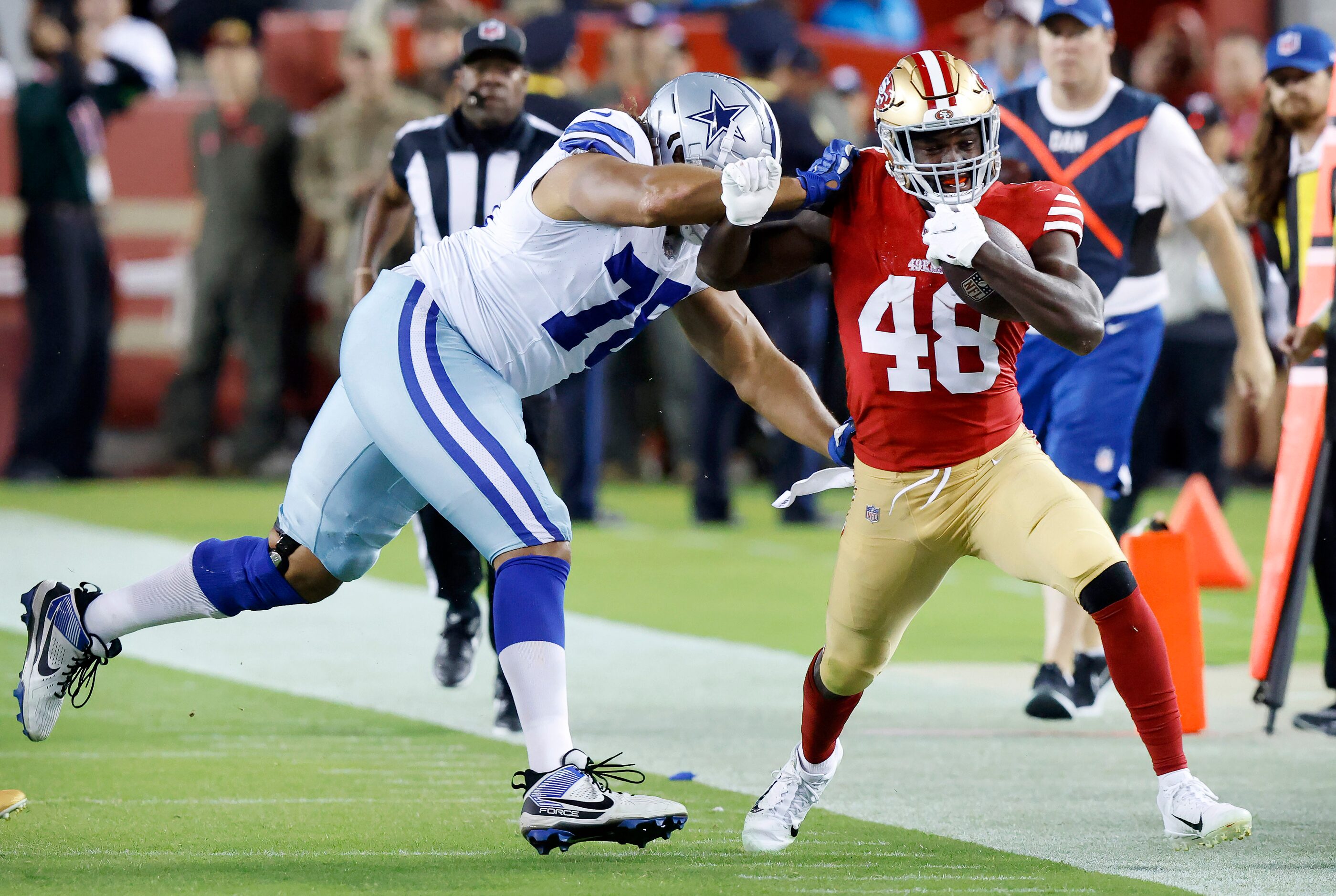 San Francisco 49ers linebacker Oren Burks (48) is forced out of bounds by Dallas Cowboys...