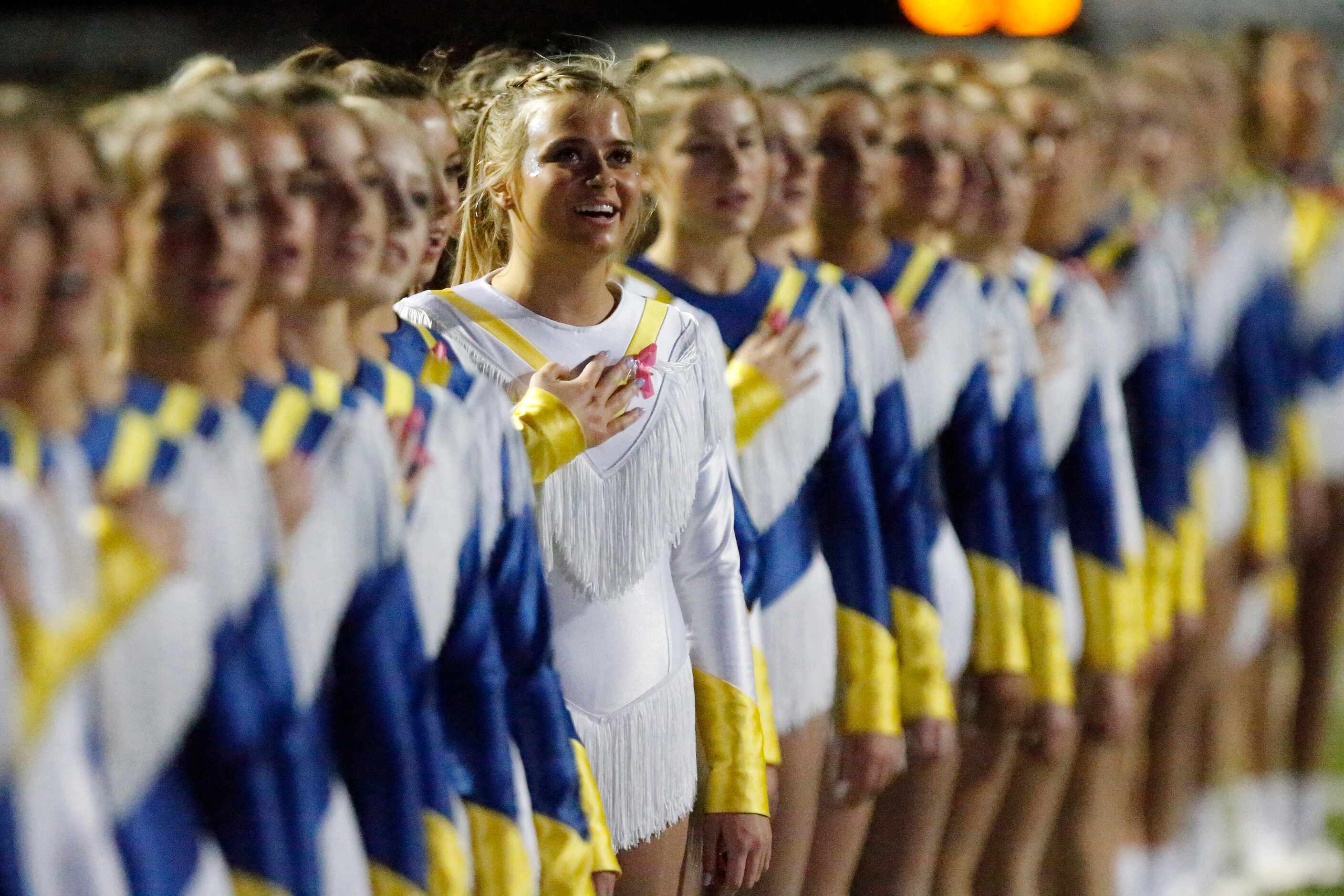 Chloe Walsh with the Highland Park High School Belles drill team stands at attention during...