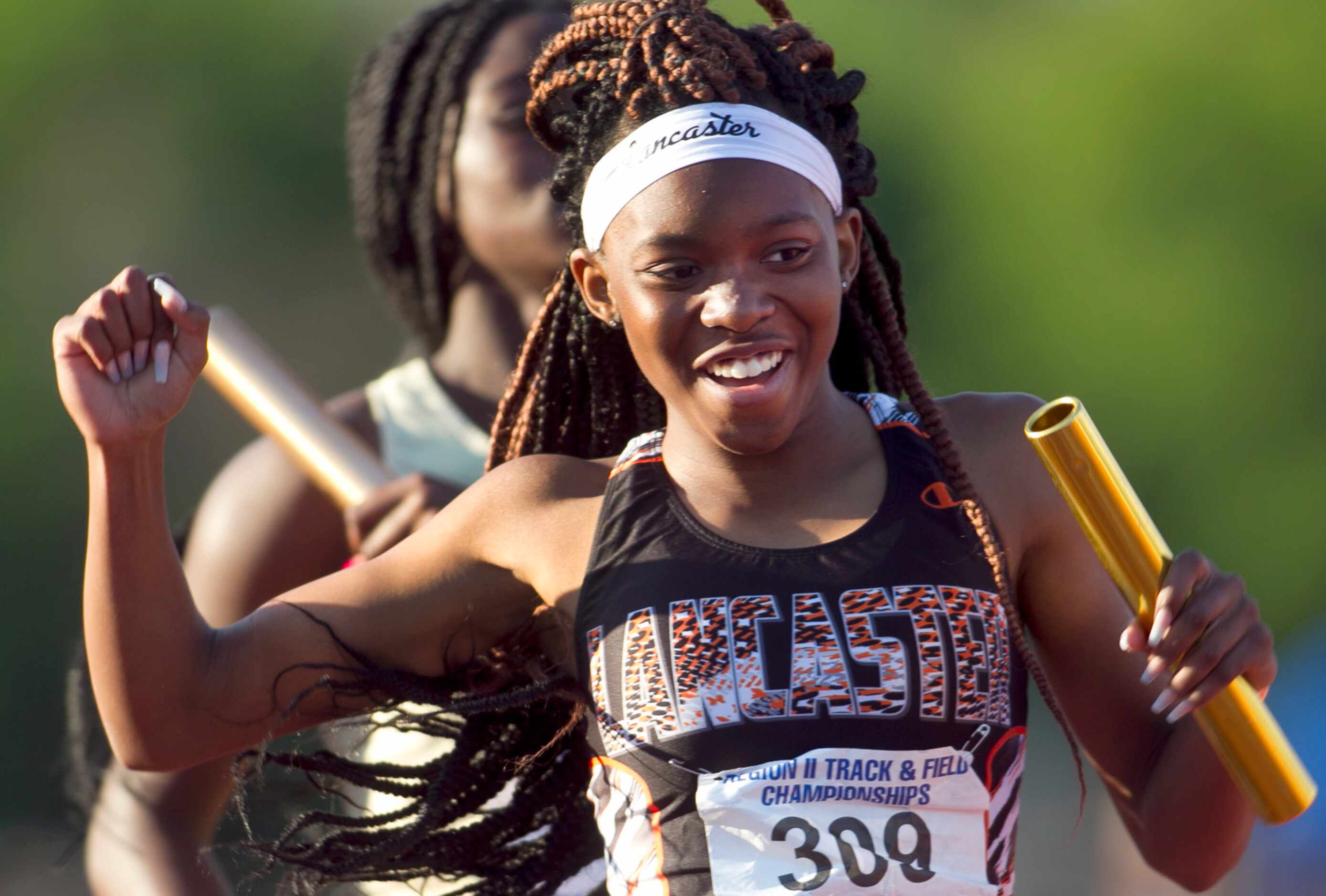 Lancaster's Addison Stricklin was all smiles as she carried the baton across the finish line...