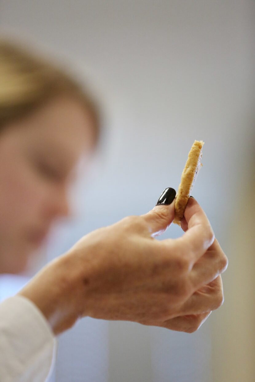 A judge holds up a cookie while judging the 22nd annual The Dallas Morning News-Central...