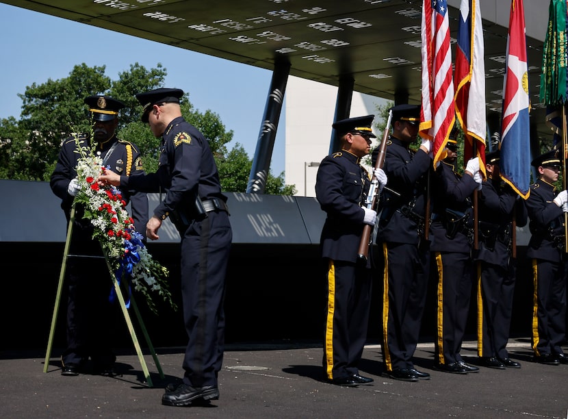 Dallas police Chief Eddie García placed a missing flower back in a 7-7 wreath at the Dallas...