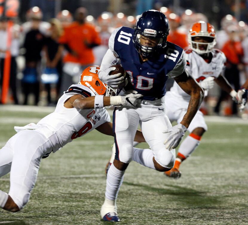 Allen's Theo Wease (10) twists free of a Rockwall defender Elijah Coleman (9) and heads to...