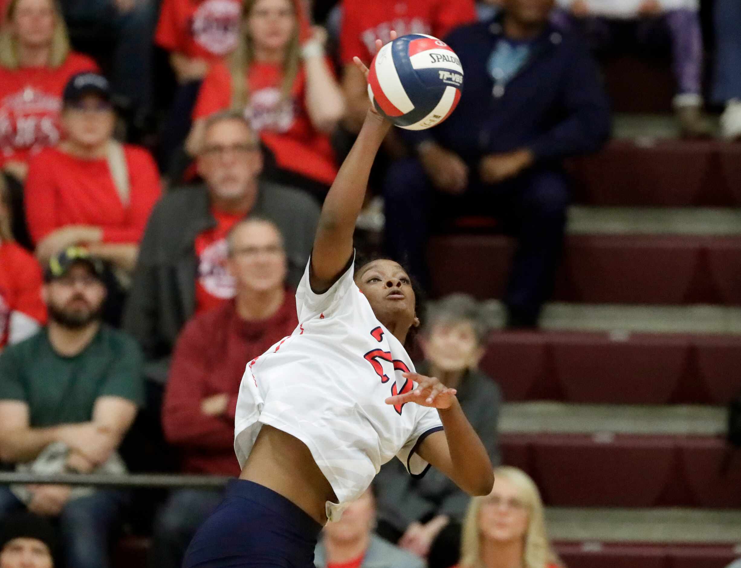 Centennial High School outside hitter Brianna Hamilton (20) gets a hit during game one as...