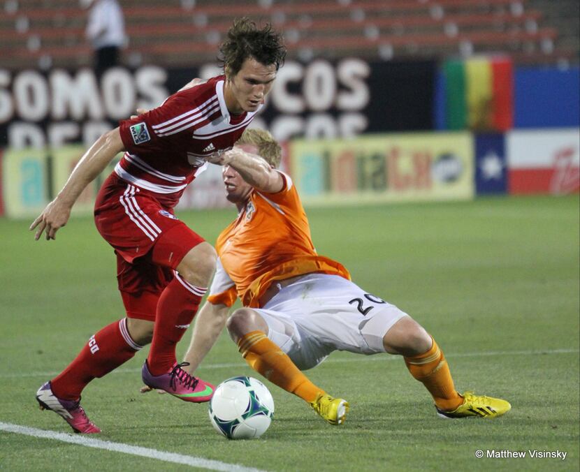12 June 2013 - FC Dallas defender Zach Loyd (#17) takes the ball from Houston Dynamo forward...