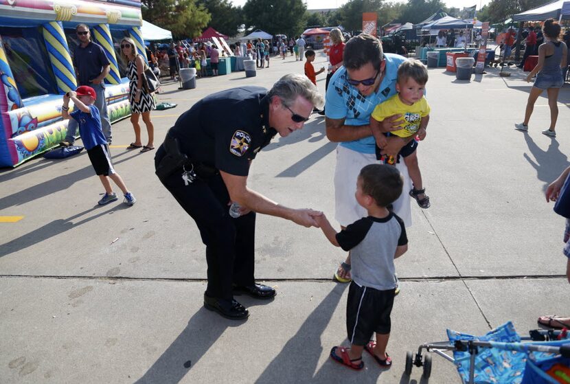 Rockwall Police Chief Kirk Riggs met Aaron Gonzalez and his sons, Tanner Gonzalez, 1, and ...