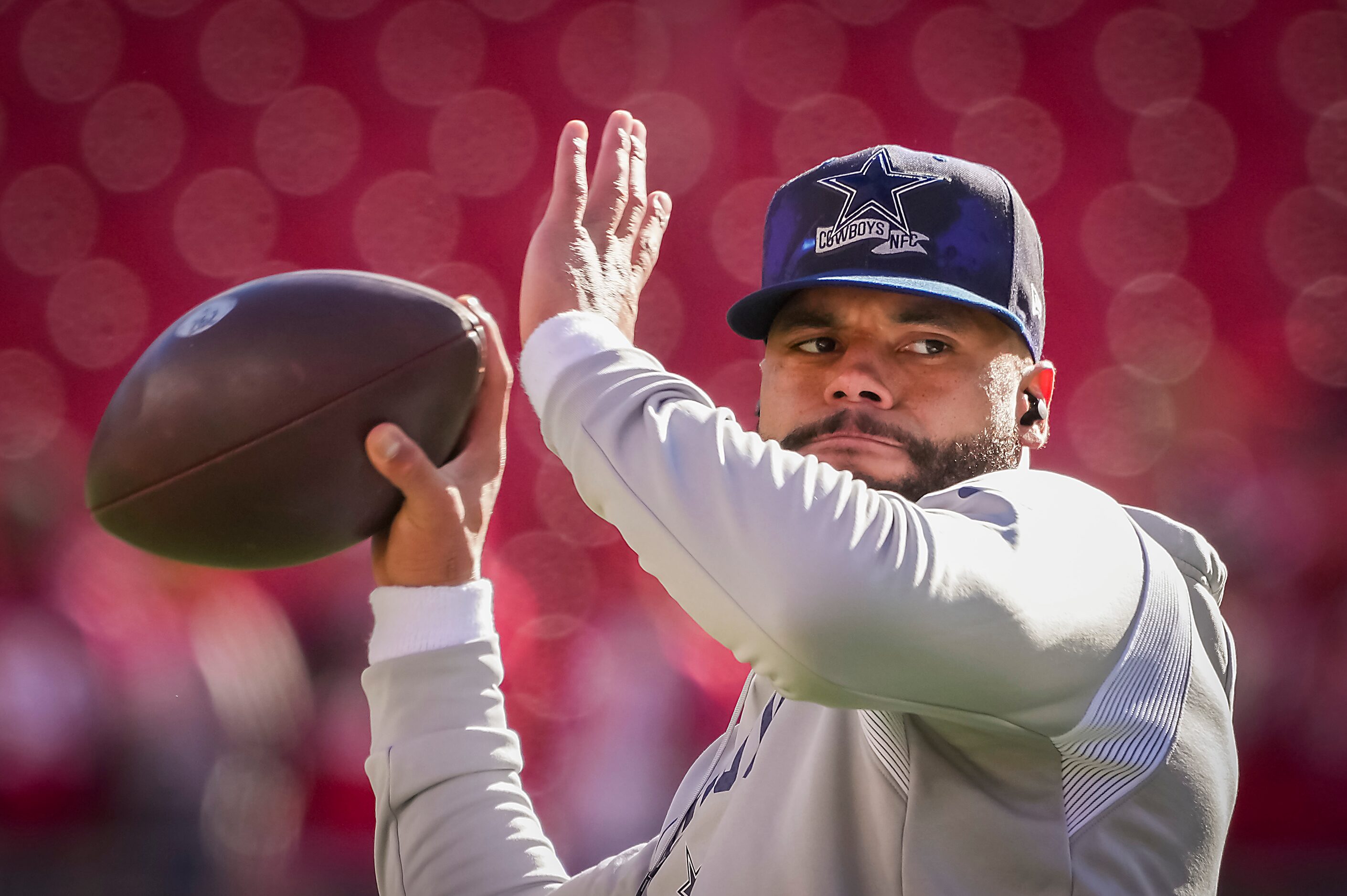 Dallas Cowboys quarterback Dak Prescott warms up before an NFL divisional round playoff...