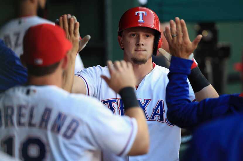 ARLINGTON, TX - APRIL 27:  Ryan Rua #16 of the Texas Rangers celebrates after scoring...