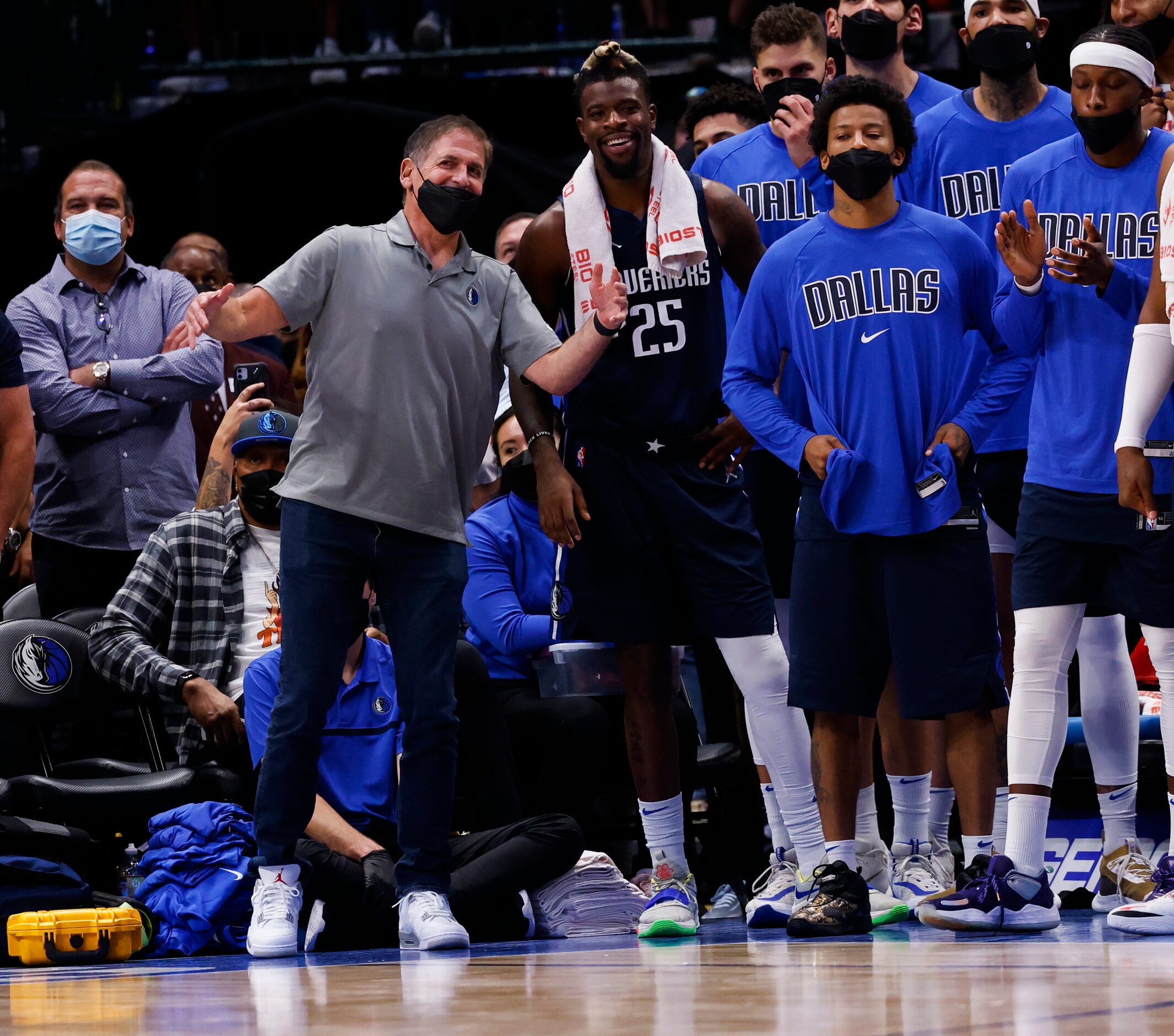 Dallas Mavericks owner Mark Cuban (in grey) watches during the fourth quarter of the Dallas...