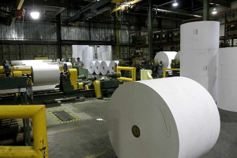A worker watches paper rolls at the paper mill Thursday Jan 12, 2006 in Groveton, N.H. The...