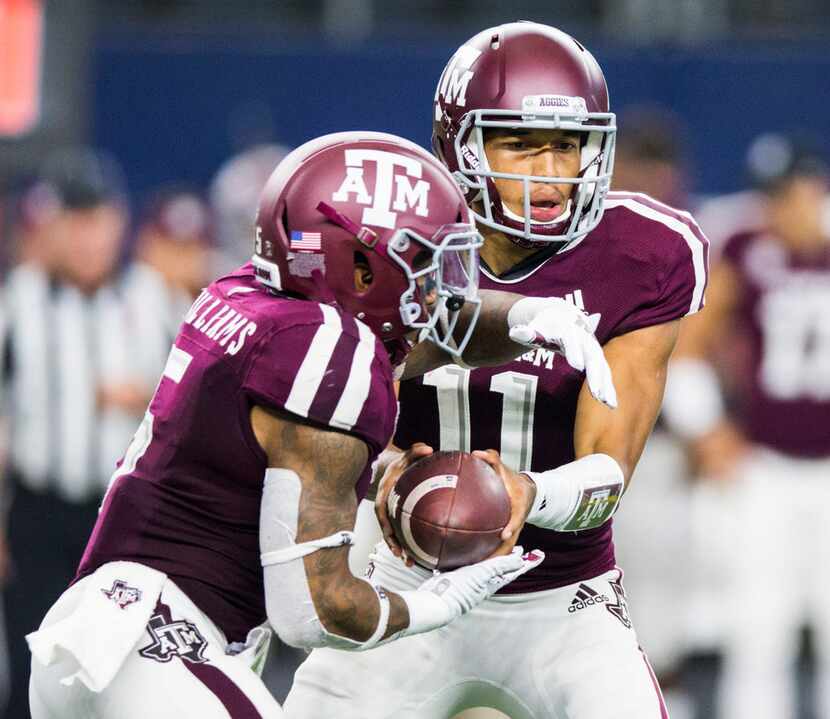 Texas A&M Aggies quarterback Kellen Mond (11) hands off the ball to running back Trayveon...