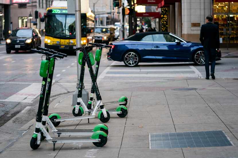 Lime electric scooters sat on the sidewalk on Commerce Street in downtown Dallas on Dec. 4,...
