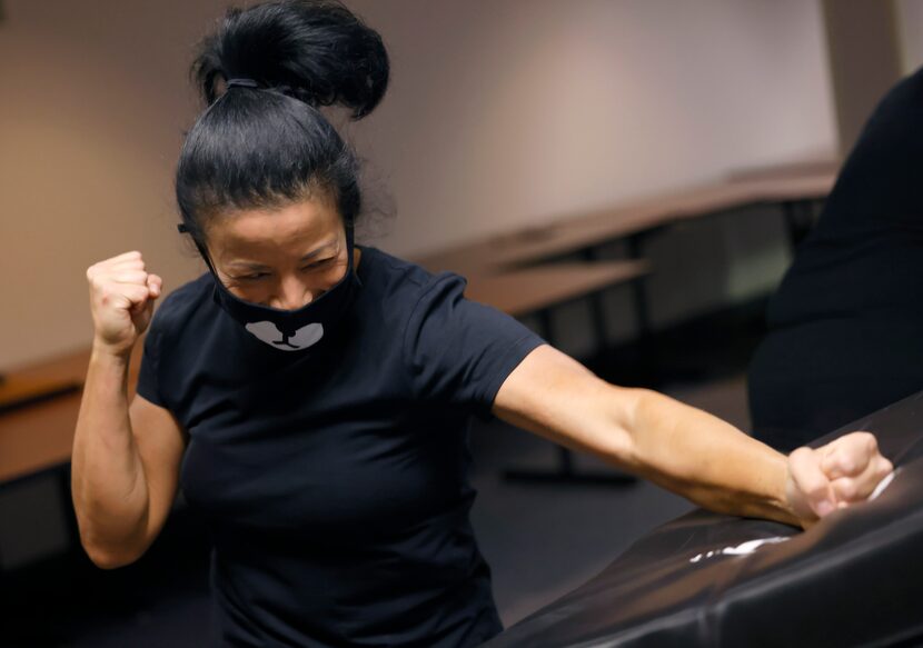 United Airlines flight attendant Elaine Lackland practices self-defense measures with a...