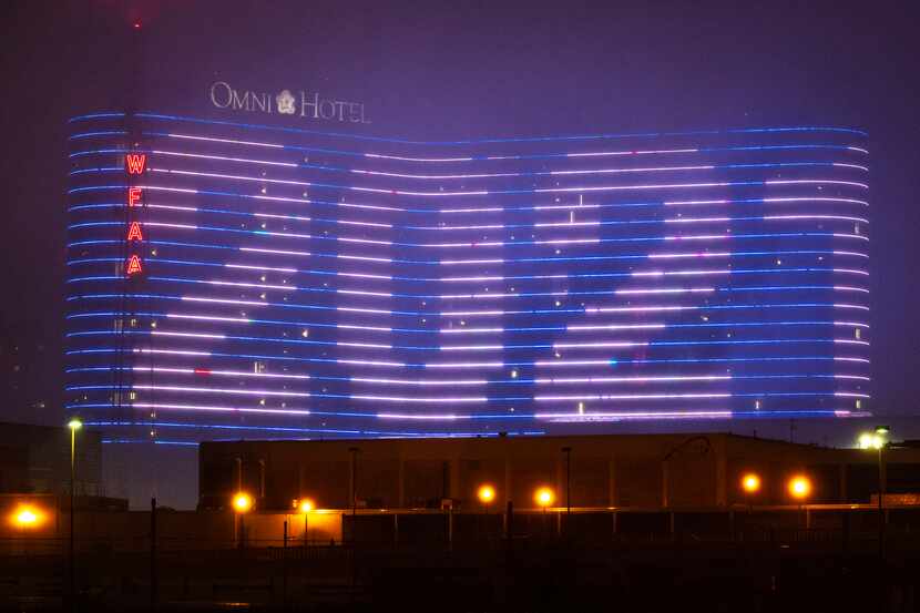 Through a light drizzle of rain and fog, Happy New Year 2021 was displayed on the electronic...