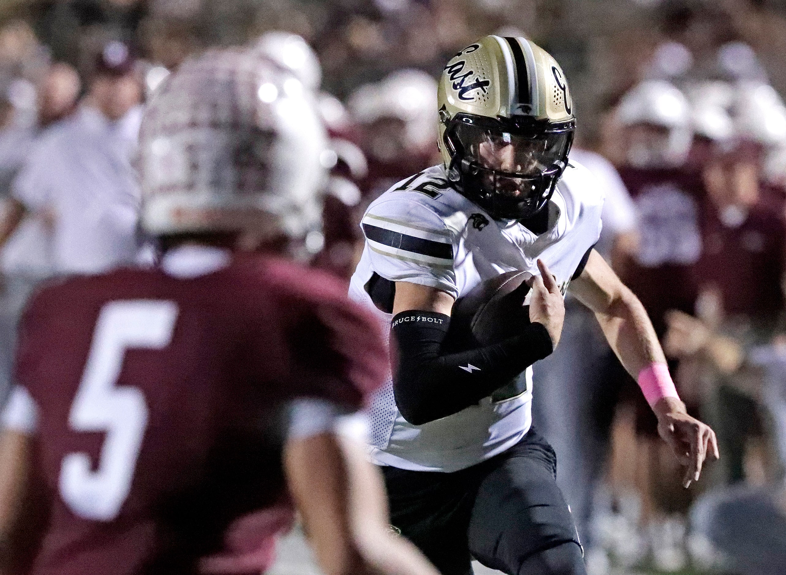 Plano East High School quarterback Jackson Hays (12) runs past Plano High School defensive...