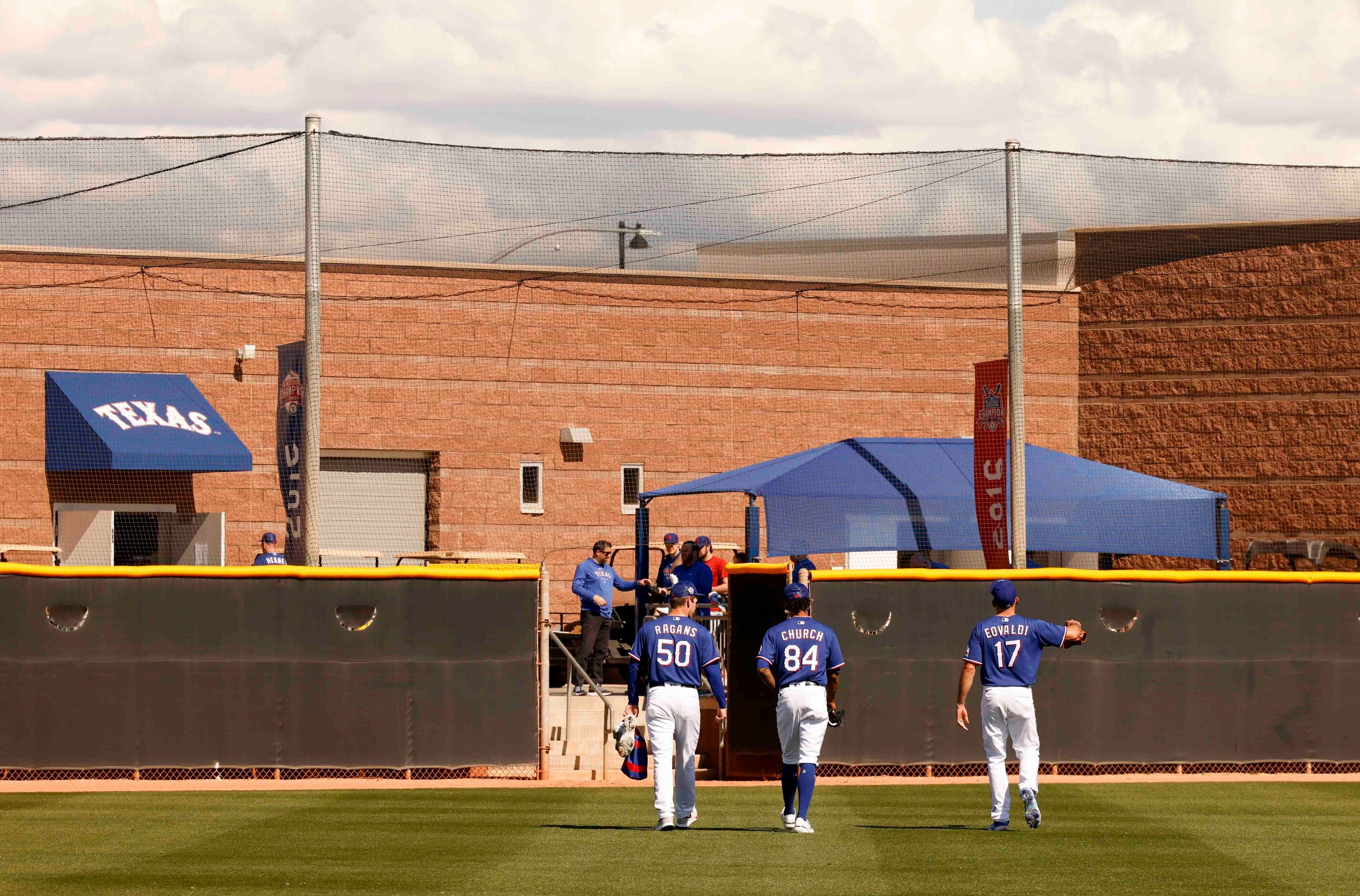 Texas Rangers pitchers Cole Ragans, left, Marc Church, center, and Nathan Eovaldi exits the...