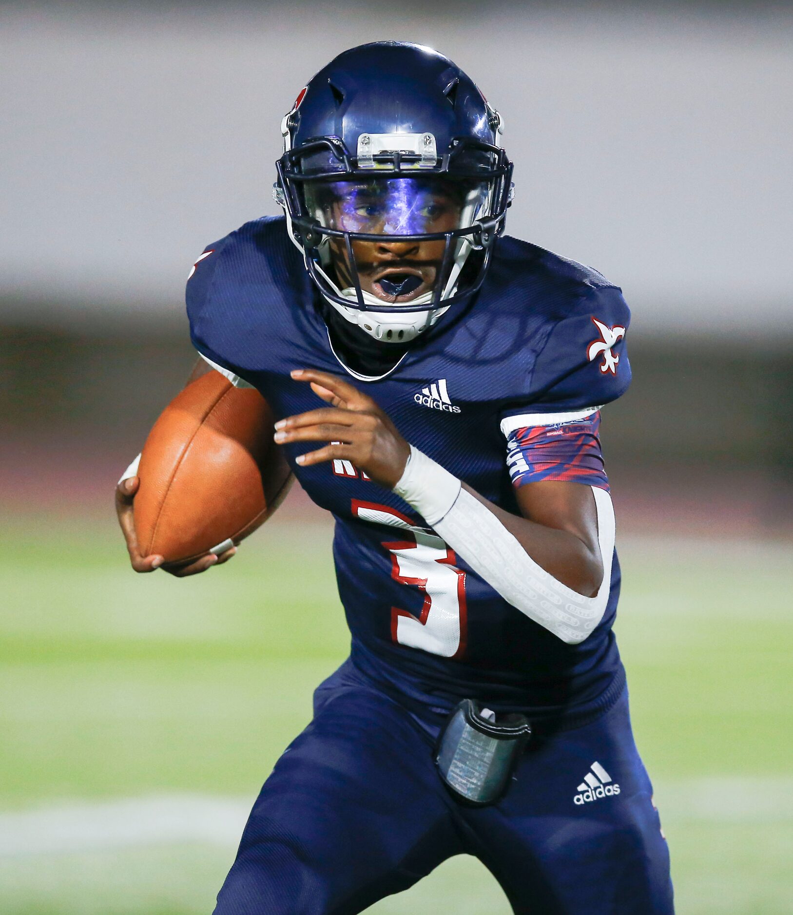 Kimball senior quarterback Jerqualan Parks looks for room against the Conrad defense during...