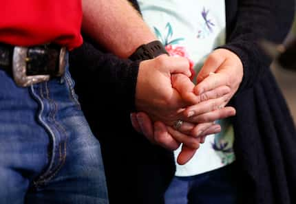 Andrew Needum and his wife Stephanie Needum held hands as they talked about their experience...