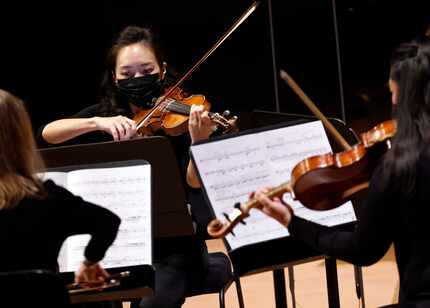 Violinist Euncie Keem performs with other members of the Dallas Symphony Orchestra in a...