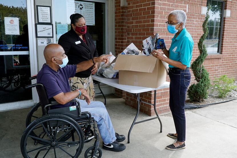 Friendly Visitor Coordinator Marsha Evans (right) delivers donations to Modern Senior Living...
