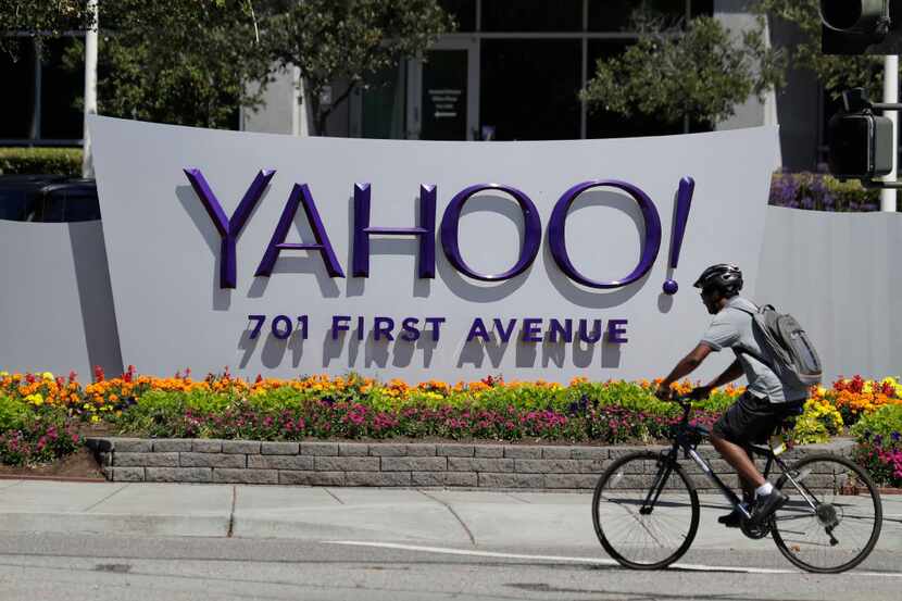 FILE - In this Tuesday, July 19, 2016 file photo, a cyclist rides past a Yahoo sign at the...