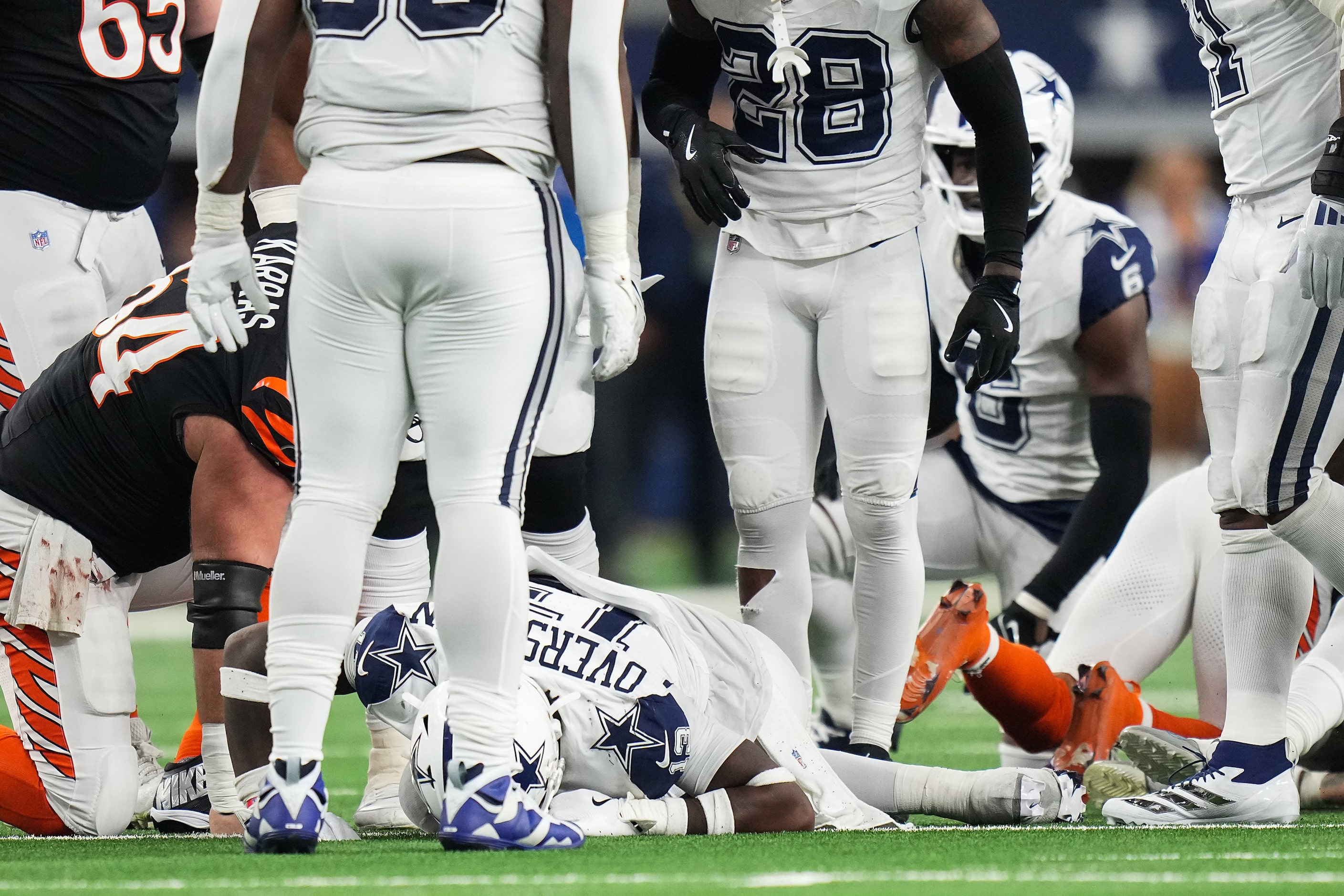 Dallas Cowboys linebacker DeMarvion Overshown (13) collapses to the turf after being injured...