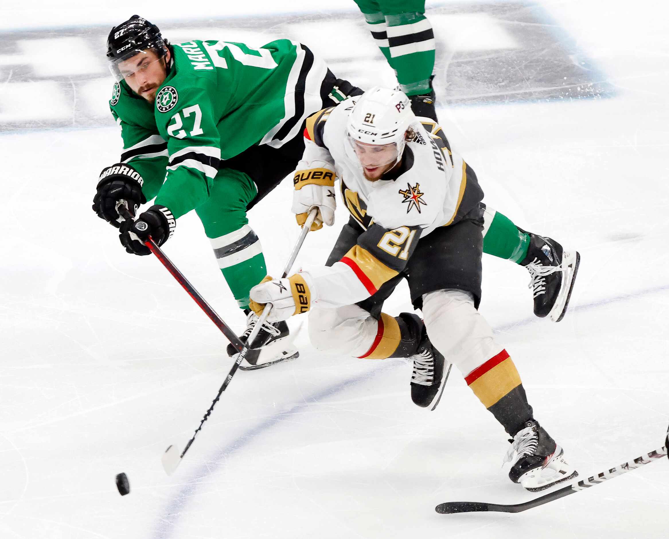 Dallas Stars left wing Mason Marchment (27) reaches for the puck as Vegas Golden Knights...