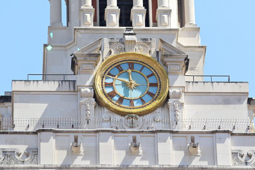 The clock on the University of Texas at Austin tower is stopped at 11:48am to mark the time...