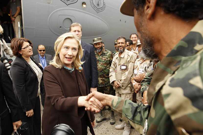 
Secretary of State Hillary Clinton meets with American soldiers upon arriving in Tripoli,...