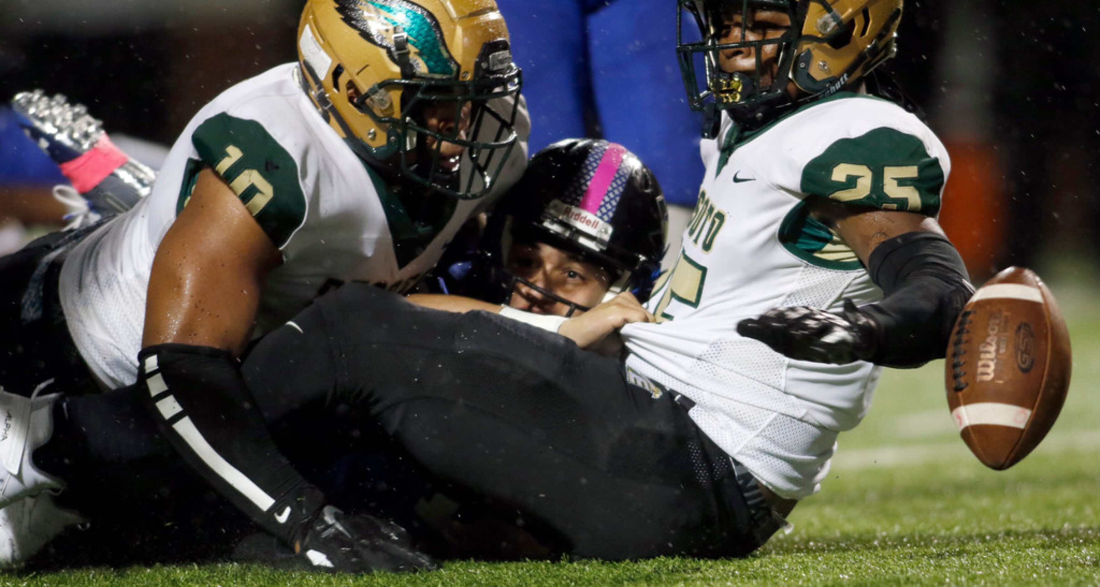 Mansfield Summit quarterback Phoenix Meza (10) is sandwiched in the backfield by DeSoto...