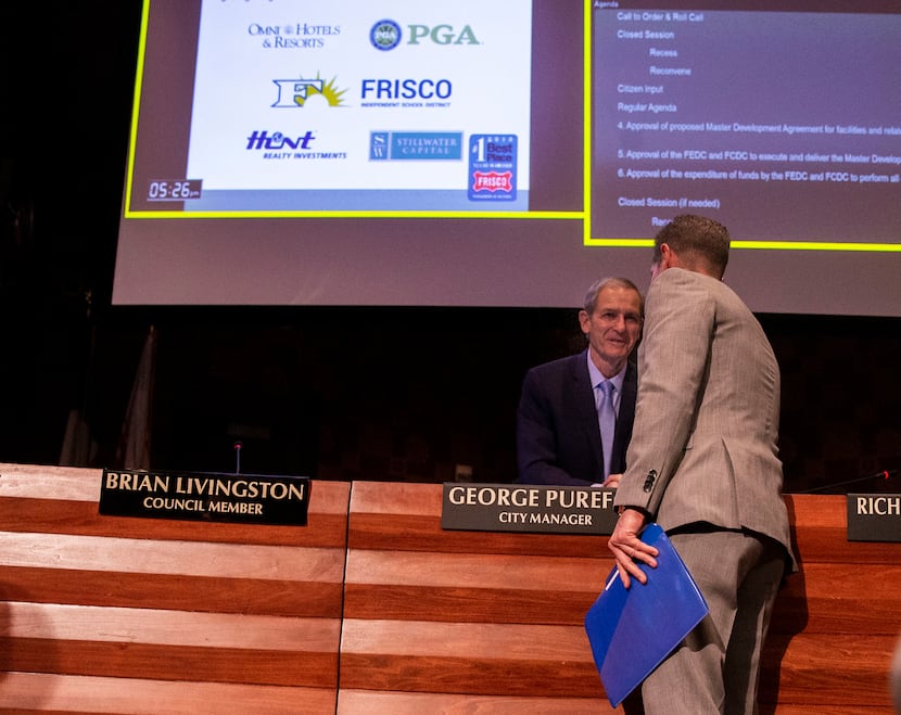 City manager George Purefoy (facing camera) shakes hands with Darrell Crall, PGA of America...