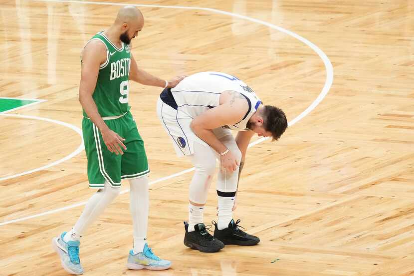 Boston Celtics guard Derrick White (9) gives him a pat on the back as Dallas Mavericks guard...