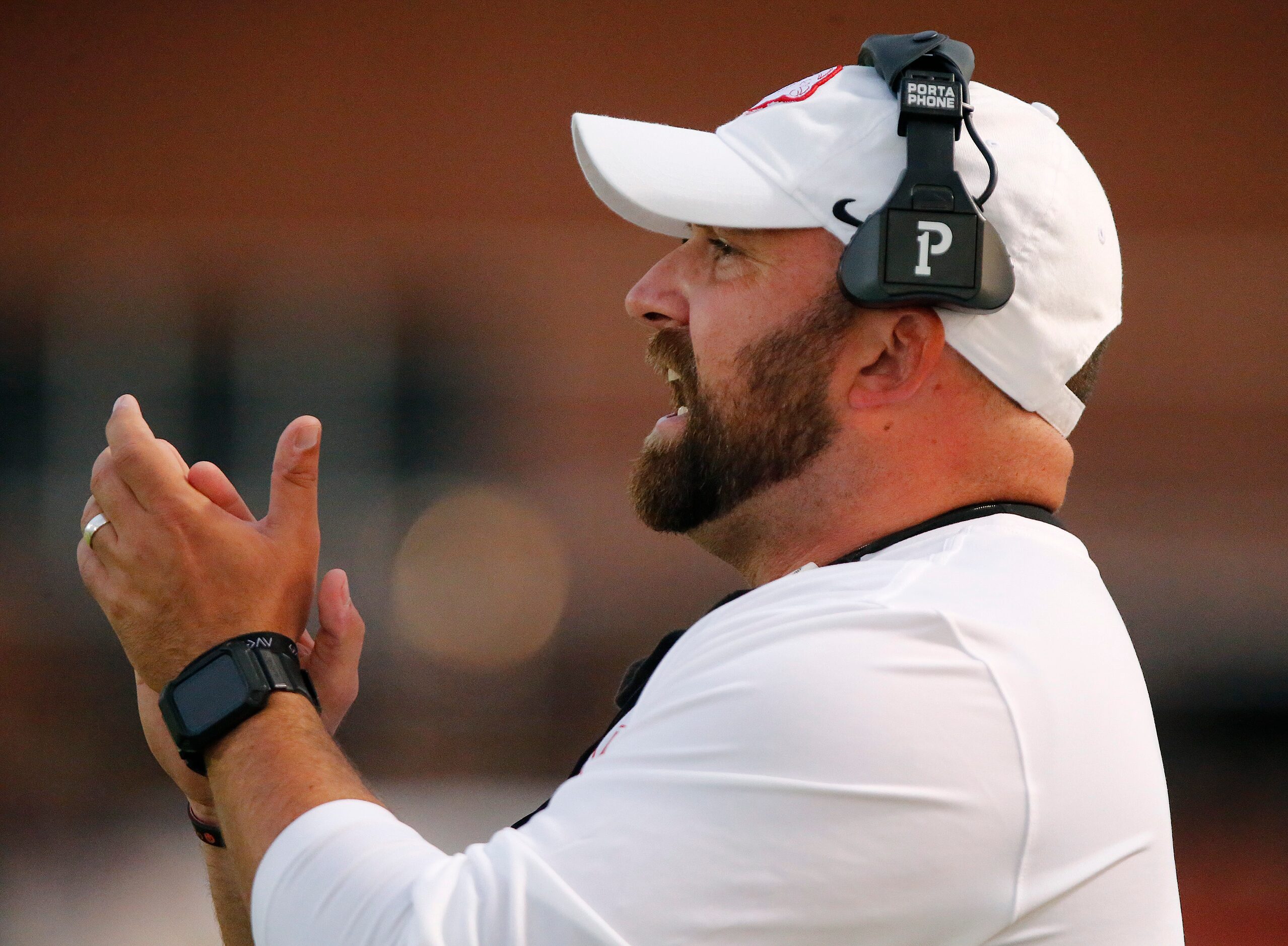 Melissa High School head coach Matt Nally cheers his team on during the first half as...