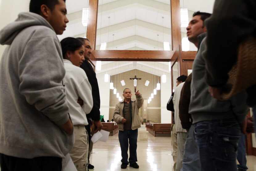 Father Edmundo Paredes spoke with church ushers during last-minute preparations for St....