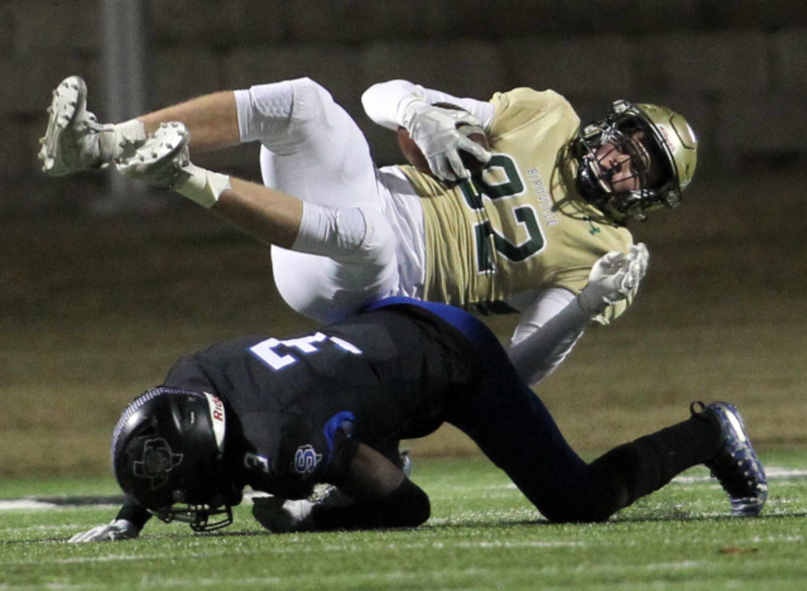Birdville tight end Connor Welsh (82) is upended by Mansfield Summit defensive back Ahmaad...