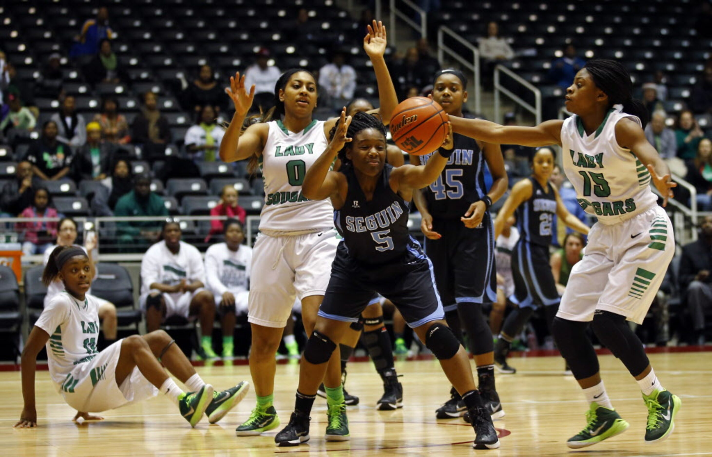 Arlington Seguin's Lisa Taylor (5) and Bryan Adams' DeBrashia Baty (15) go for the loose...