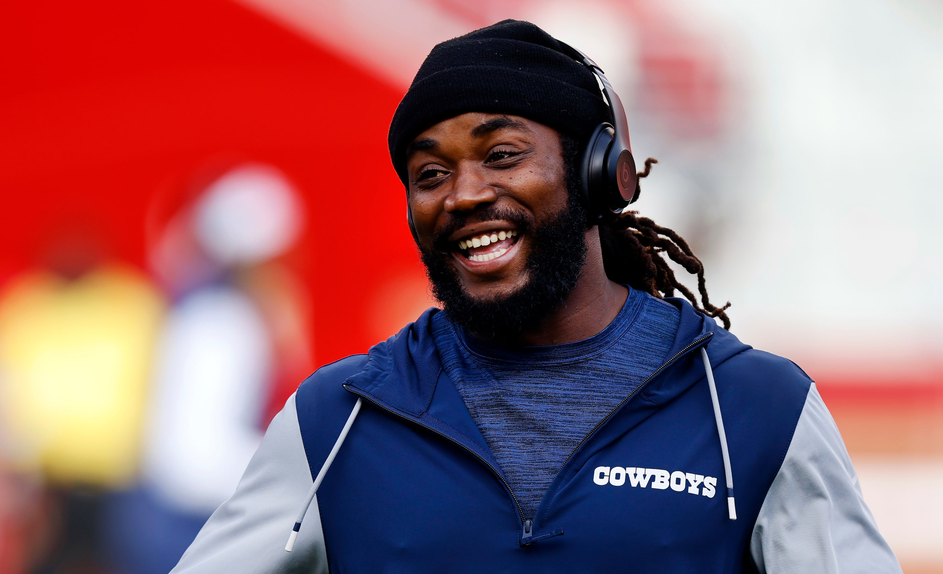 Dallas Cowboys running back Dalvin Cook smiles as he warms up before facing the San...