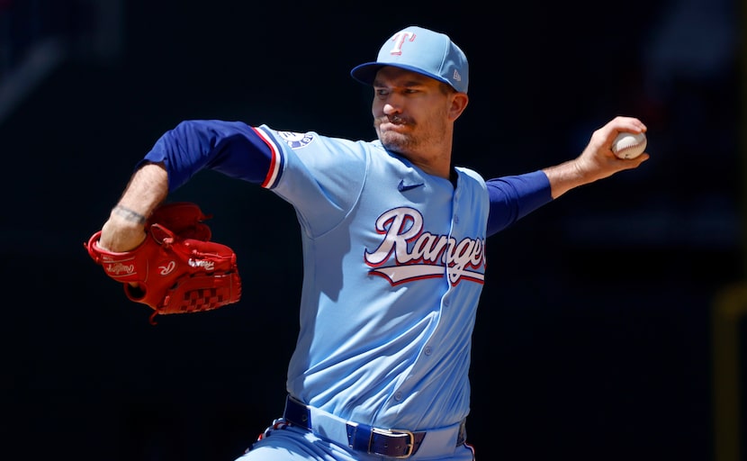 Texas Rangers starting pitcher Andrew Heaney hurls a pitch while facing the Los Angeles...