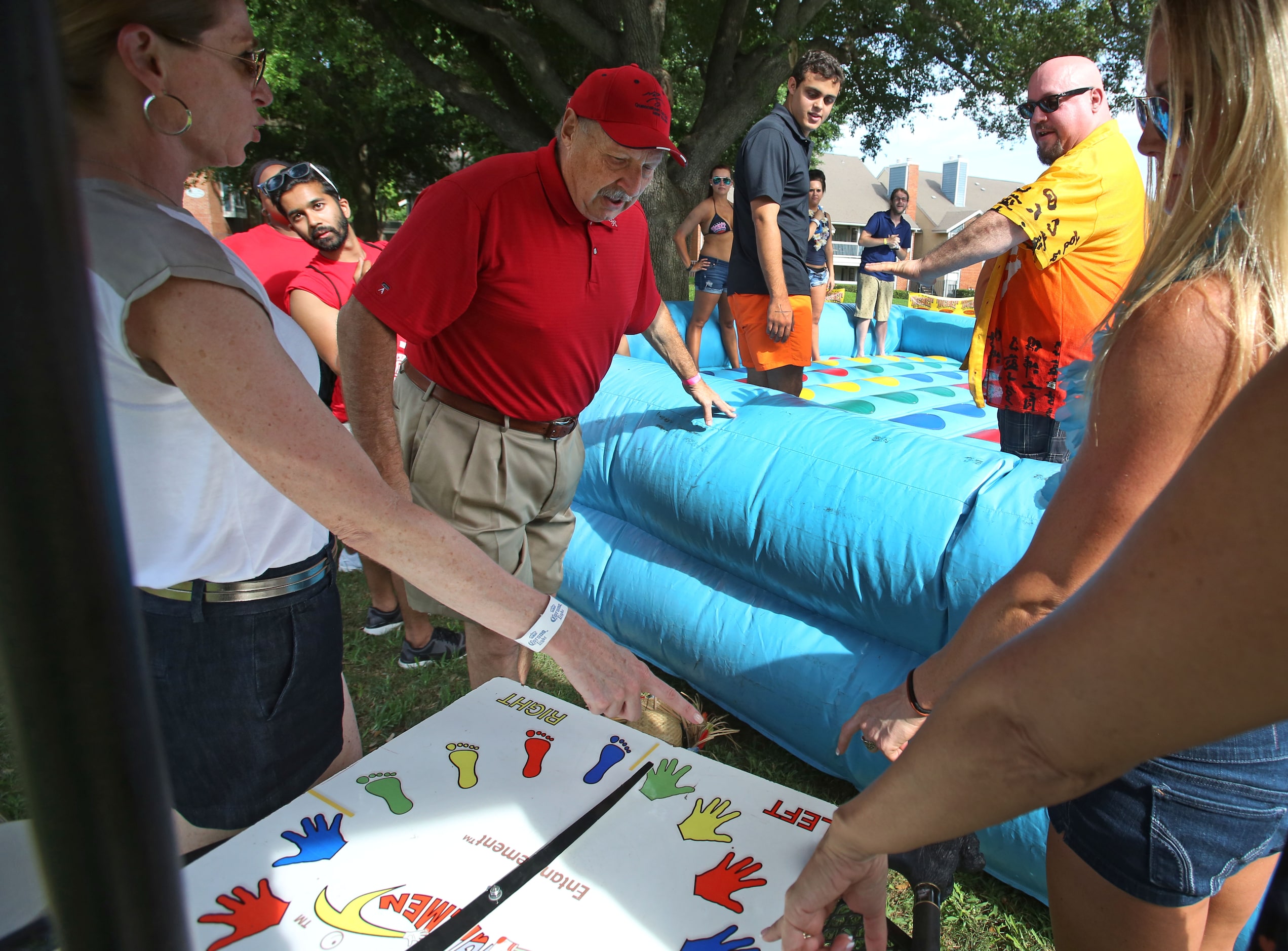 The Ticket radio personality Norm Hitzges, center, oversees a game of twister during The...