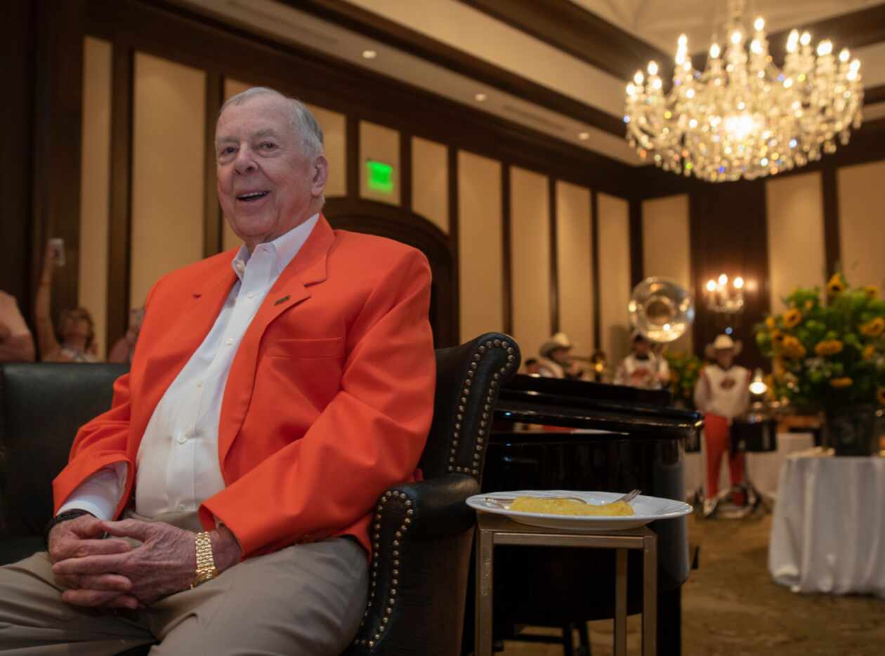 T. Boone Pickens listens to the Oklahoma State University band play during his 90th birthday...