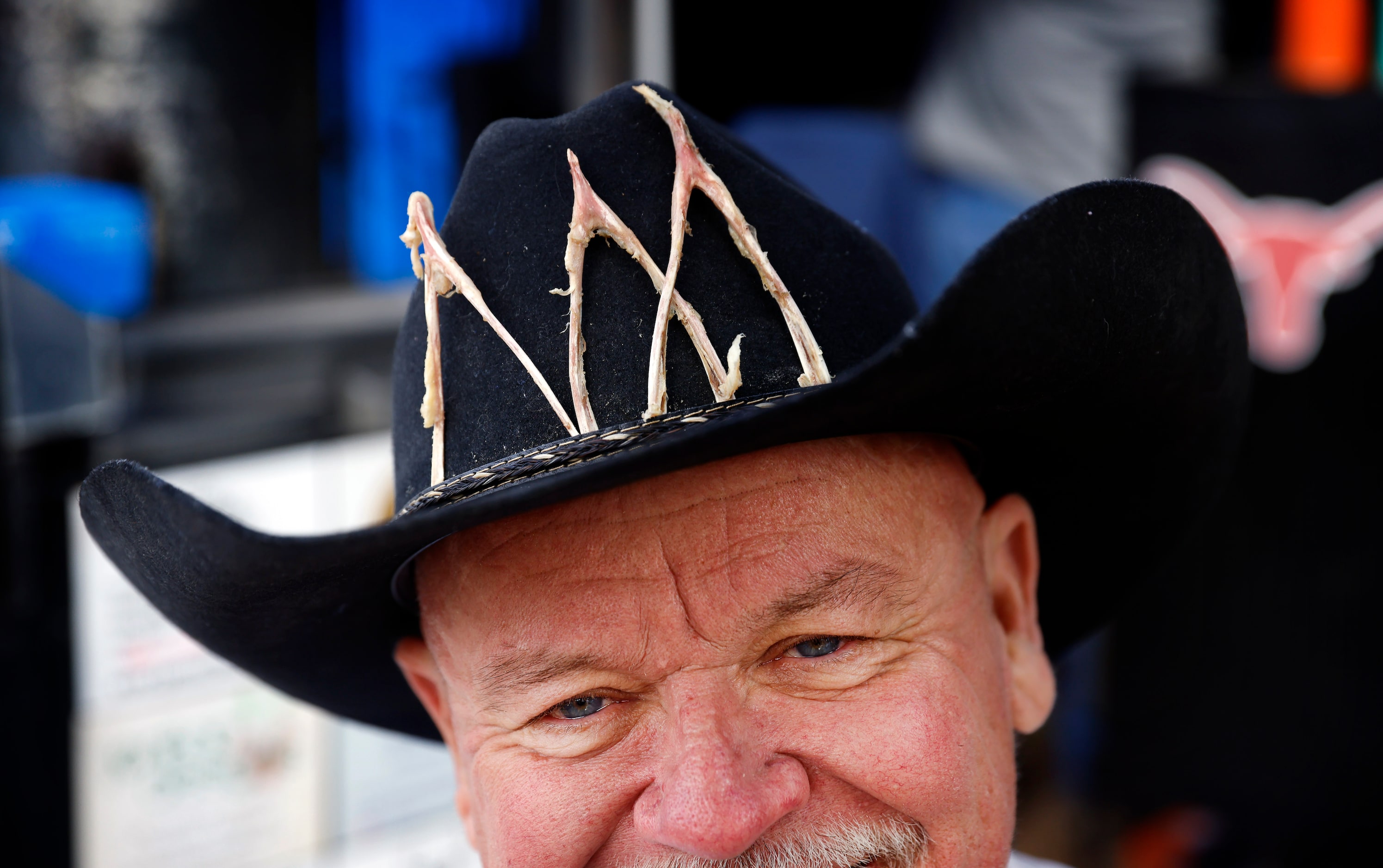 Lot 4 Gate 6 Tailgaters co-founder Cy Ditmore wears a wishbone-laden cowboy hat in honor of...