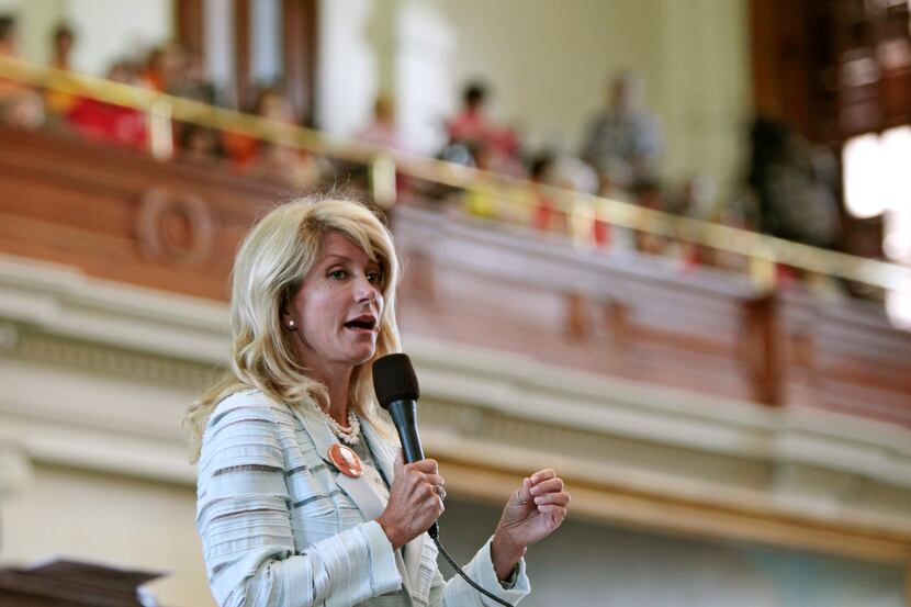  Then-Texas State Sen. Wendy Davis speaks during her 2013 filibuster against a bill...