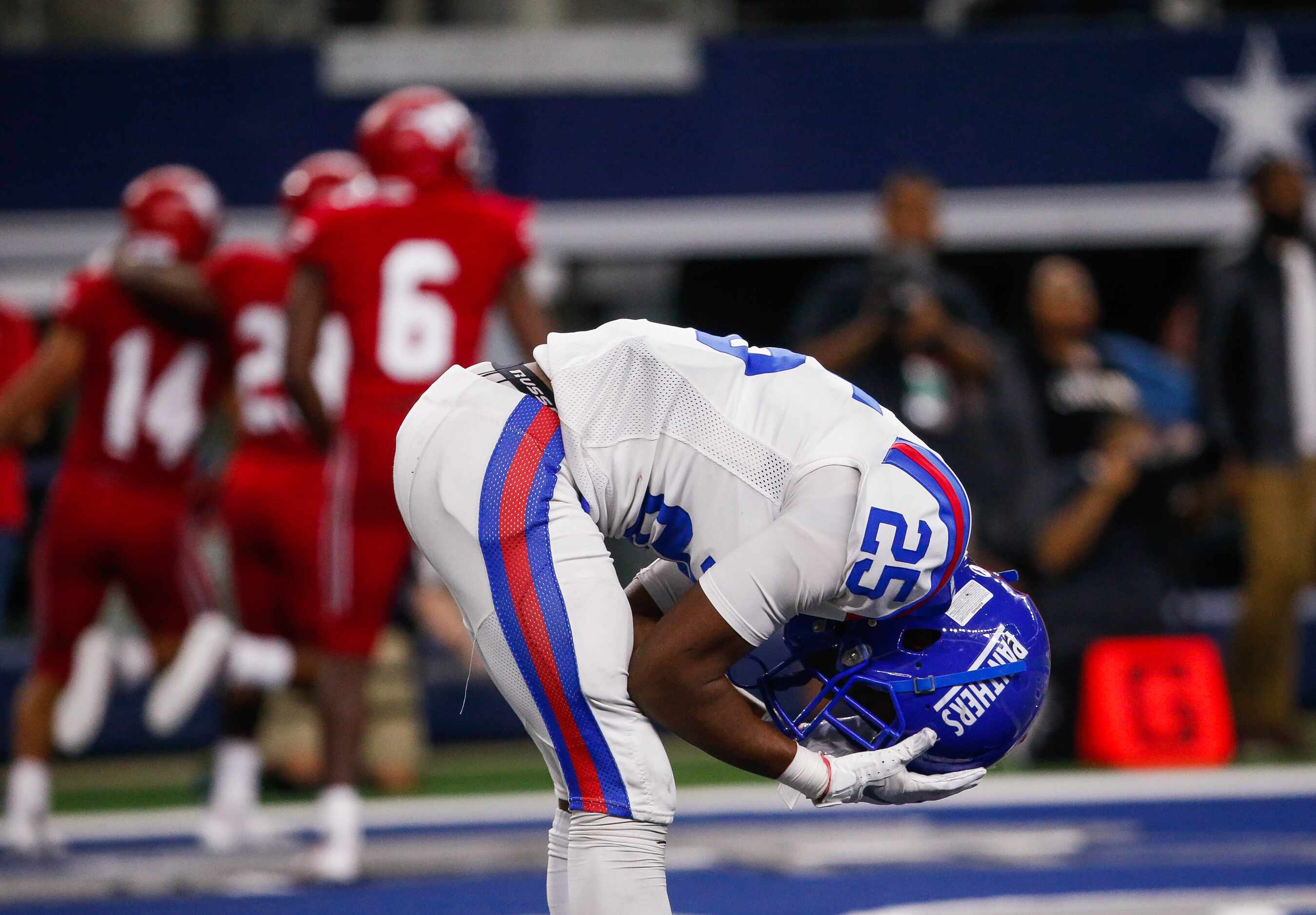 Duncanville's DB Thailan Scott (25) reacts to North Shore's Roger Hagan's (15) touchdown in...