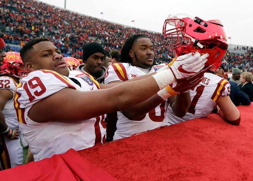 Iowa State defensive end JaQuan Bailey (19) holds his helmet upside down after Iowa State...